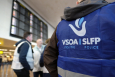 Illustration shows protesting officers wearing the logo of VSOA - SLFP police union inside the departure hall of Brussels airport in Zaventem. (BELGA PHOTO ERIC LALMAND)