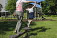 Illustration picture shows an adult holding a girl playing in a playground in Brussels, Wednesday 27 May 2020. Many parents had to take time off or find alternative childcare during the first wave of the coronavirus crisis when the schools were closed. (BELGA PHOTO THIERRY ROGE)