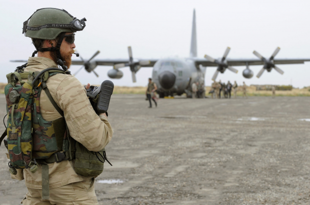 A Belgian soldier keeps an eye on a Belgian C-130 plane in Kunduz airport, Afghanistan, Tuesday 02 June 2009. Belgium will begin to bring its soldiers home from Afghanistan in 2021. (BELGA PHOTO BENOIT DOPPAGNE)