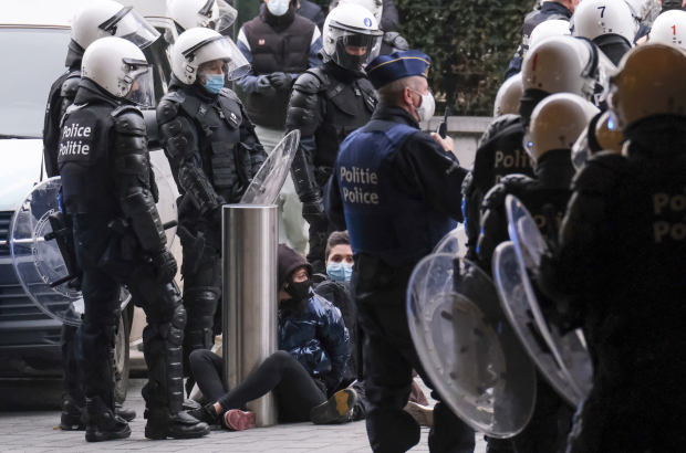 Illustration shows police with arrested demonstrators outside the Central Station, Sunday 24 January 2021, in Brussels. (BELGA PHOTO NICOLAS MAETERLINCK)