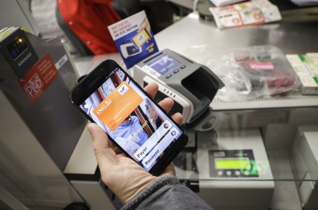 Illustration picture shows payment by smartphone in a Delhaize supermarket in Brussels. (BELGA PHOTO THIERRY ROGE) Illustration picture shows payment by smartphone in a Delhaize supermarket in Brussels. (BELGA PHOTO THIERRY ROGE)