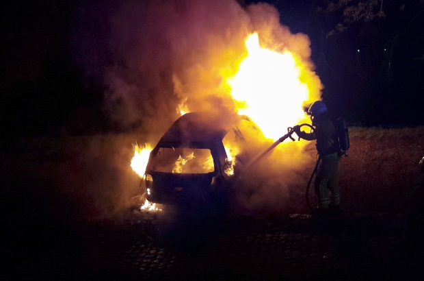 A fire officer attends to a burning car in Namur (Belga image) A fire officer attends to a burning car in Namur (Belga image)