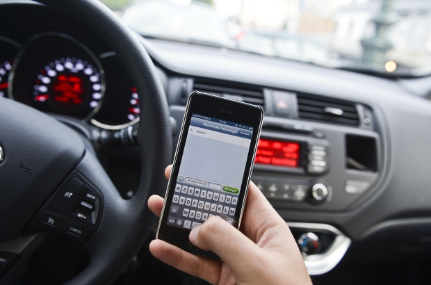 Illustration picture shows a driver writing a text message on his cell phone while driving a car (BELGA PHOTO LAURIE DIEFFEMBACQ) Illustration picture shows a driver writing a text message on his cell phone while driving a car (BELGA PHOTO LAURIE DIEFFEMBACQ)