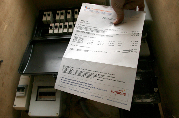 illustration picture shows a bill in front of an electricity meter in a house. (BELGA PHOTO MICHEL KRAKOWSKI)
