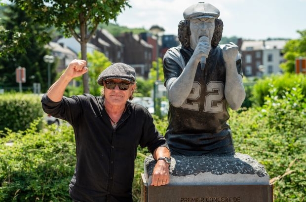 AC/DC singer Brian Johnson next to his statue in Namur