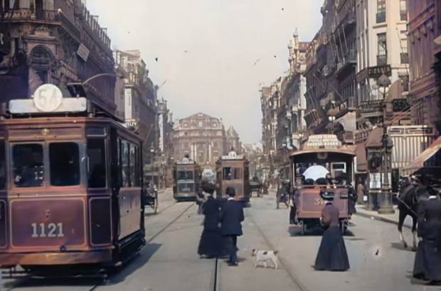 A screenshot taken from the colourised video shows trams and pedestrians on Boulevard Anspach, Brussels, in 1908 (YouTube / Rick88888888 / Prelinger Archive)