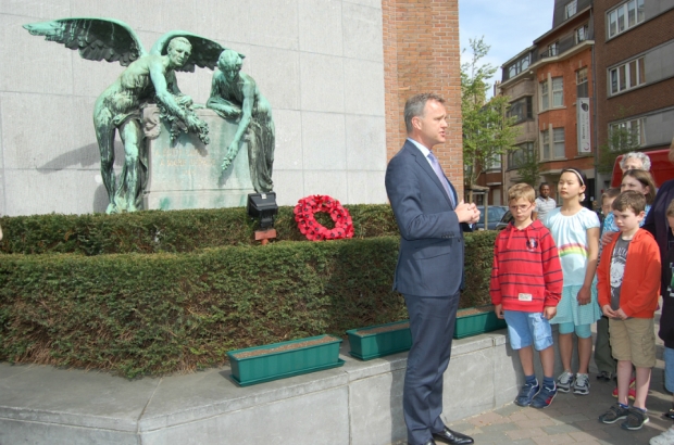 -	Left to right: Memorial, window boxes where poppies were planted (the children took them to school garden to nurture in time for August), Minister, children from The British School of Brussels
