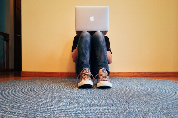 A young person sits and stares at a laptop (Creative Commons Licence)