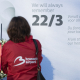 Airport workers stand in front of the remembrance wall after a tribute ceremony for the victims of the 2016 terrorist attacks at the departure hall of Brussels airport in Zaventem. On March 22 2016, 32 people were killed and 324 got injured in suicide bombings at Brussels airport and the Brussels' subway. (BELGA PHOTO BENOIT DOPPAGNE)