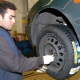 BRUSSELS, BELGIUM: Worker in a tyre specialist shop, replacing a tyre on a car. (BELGA PHOTO HERWIG VERGULT)