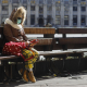 Illustration picture shows a woman sitting alone on a bench and wearing a mask in the Grand-Place in Brussels, Wednesday 18 March 2020. (BELGA PHOTO THIERRY ROGE)