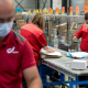Illustration picture shows postal workers at a distribution centre of Belgian postal service Bpost in Braine l'Alleud. Post services notice a large rise in the distribution of packages, as more people order things online due to the strict corona-crisis security measures. BELGA PHOTO POOL DANNY GYS