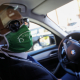 Illustration picture shows a taxi driver wearing a mouth mask, seen through a plexiglass screen at the headquarters of Taxi Verts, in Forest - Vorst, Brussels, Thursday 28 May 2020. (BELGA PHOTO THIERRY ROGE)