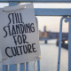 A 'Still Standing' sign shown during a protest of the cultural sector, in Liege, Saturday 20 February 2021. The cultural and creative sectors are struggling as events have been cancelled because of the pandemic. (BELGA PHOTO THOMAS MICHIELS)