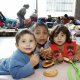 Children of the homeless refugees families who are living inside the North station in Brussels eat donated food. (BELGA PHOTO NICOLAS MAETERLINC)