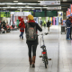 A lady walks through a Belgian trains station with her bicycle (BELGA PHOTO THIERRY ROGE)