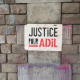 A sign on a wall in Anderlecht, Brussels, calling for justice for 19-year-old Adil who was killed in a police chase in April 2020 (© Wikipedia Creative Commons / All Rights Reserved)